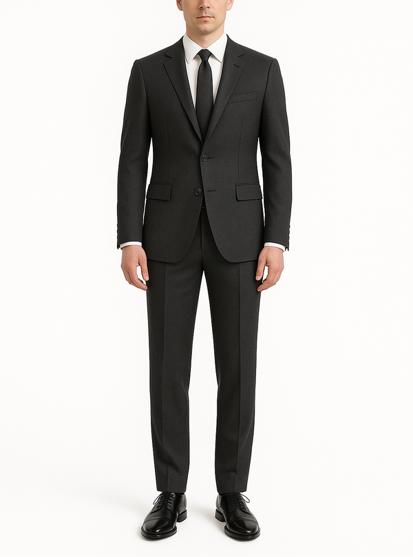 Man wearing a black suit with a white shirt and black tie on a white background