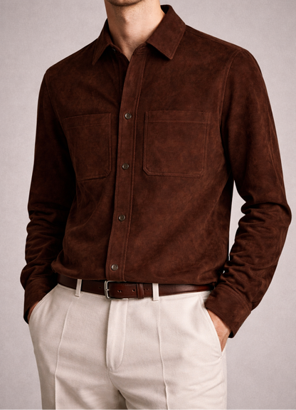 Man wearing a brown suede shirt with beige pants against a plain background