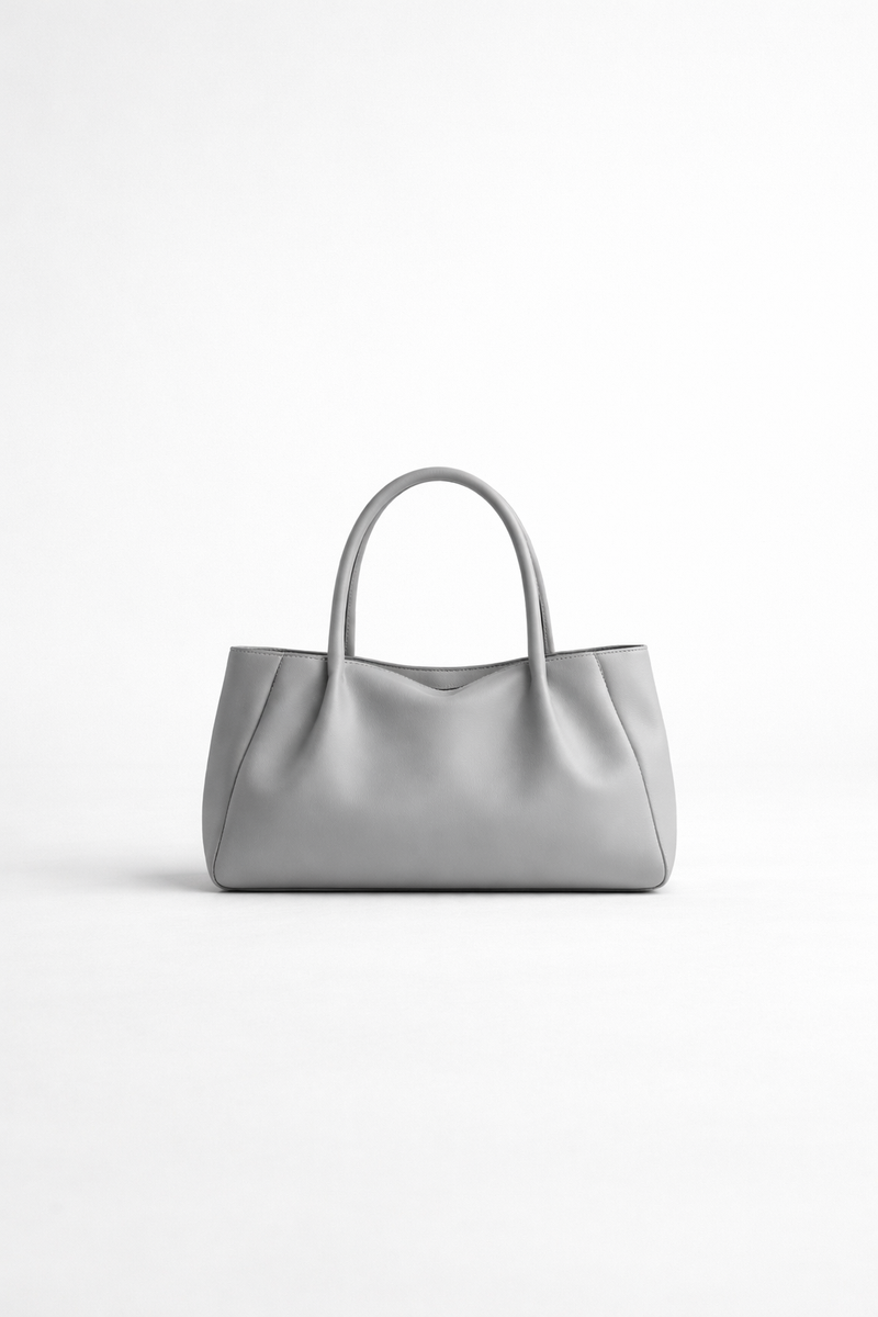 Mist grey soft leather handbag centered on white background